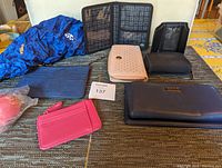 View of all six wallets and cardholders in different colors and styles on dark surface.