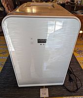 Front view of the portable white personal fridge with digital controls and display on front faceplate.