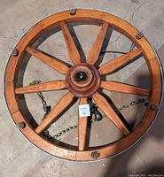 Top-down view of the wagon wheel hanging lamp, showing its eight wooden spokes and the central wiring for the light.