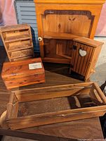 Photo showing all wood items including cabinet, toilet paper holder, shelf, Canadian Classics box, wooden box, and tray