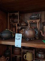 Group view of shelf showing all teapots and stands