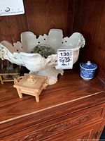 Large white ceramic ornate bowl, small wooden box, bamboo stand with figurine, blue and white lidded container, green bead necklace