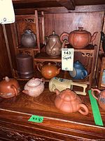 Overall assortment of teapots on wooden display stand