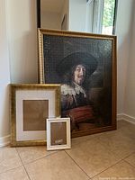 Photo showing large framed vintage puzzle and two smaller frames against wall