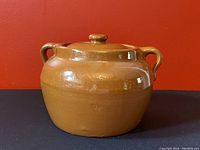 Front view of brown glazed Alberta Potteries Redcliff crock with lid and two handles