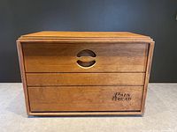 Front view of large teak bread box showing smooth finish, two sliding panels and engraved text 'PAIN BREAD'