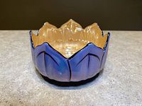Front side view of lotus flower shaped lusterware bowl showing iridescent glaze and petal details