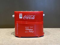 Front view of red Nostalgia Coca-Cola hot dog toaster with branding and slogan 'Enjoy That Refreshing New Feeling!'