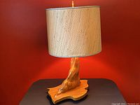 Front view of vintage cypress burl wood lamp with natural burlap lampshade, showing the irregular wood base and textured shade.