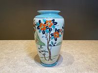 Front view of vintage 7.25 inch porcelain vase showing hand-painted orange flower tree and country landscape with lusterware finish and light blue trim.