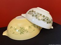 Two Pyrex Cinderella bowls stacked showing size difference and patterns