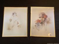 Two framed Sara Moon prints laid side by side, showing portraits of women in vintage soft pastel style.
