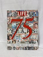 Front cover of Life The Very Best of Life 75 Years hardcover book featuring a collage of Life magazine covers and a large '75 Years' in red.