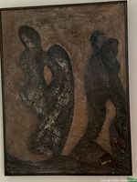 Full view of the textured multimedia figurative artwork showing abstract human figures set against an earthy background, framed.