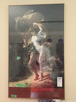 Framed poster leaning against white wall showing full image