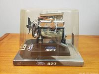 Front side view showing the engine model's detailed components and casing with Ford 427 logo on base and top left corner