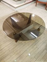 Full view of round table showing overall shape and tinted glass top