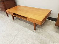 Angled front-left view showing overall form, two drawers and open shelf