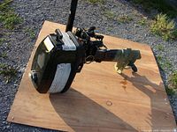 Overall view of motor laid on plywood showing engine, shaft and prop housing