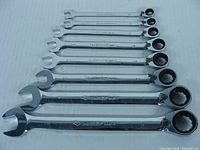 Photo of 8 Husky ratchet wrenches arranged in ascending size order, showing open and ratchet box ends with size markings visible.