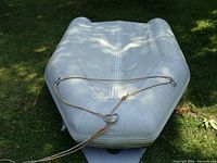 Front (bow) view of dinghy on grass with rope attached