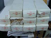 Stack of eleven white boxes labeled 'OAK 900X150 (4P) X 15MM LIGHT'