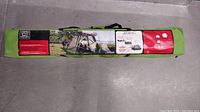 Sealed green carrying bag showing full packaged screen house