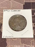 Obverse side of 1842 Gibraltar copper coin showing profile of female figure with handwritten label.