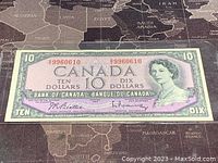 Front side of the 1954 Canadian ten dollar bill with portrait of Queen Elizabeth II and serial numbers.