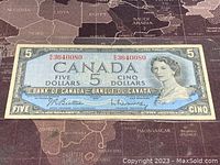 Front view of the 1954 Canadian five dollar banknote showing full design and serial number.