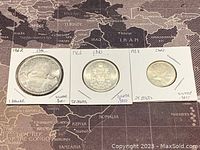 Three Canadian silver coins from 1962 labeled with denominations and silver content, mounted in white cardboard holders with staples.