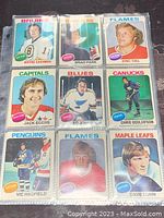 Front side of nine hockey cards showing player portraits and team logos. Players include Wayne Cashman (Bruins), Brad Park (Rangers), Eric Vail (Flames), and others.