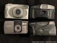 Top view of all four cameras together showing front lens, flash, and branding details.