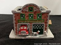 Front view showing fire hall facade with fire truck and dalmatians.