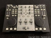 Front view of Hercules DJ Control Steel with dual jog wheels, multiple faders, knobs, and buttons on black and silver panel.
