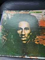 Front cover of Bob Marley & The Wailers 'Natty Dread' vinyl album showing artistic portrait of Bob Marley with worn condition.