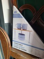 Box showing image and text of the bamboo corner shelf for kitchen or home use.