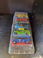 Five Peanuts-themed collectible toy cars in original clear plastic packaging