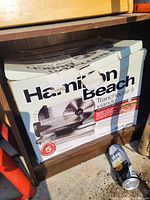 Box of Hamilton Beach meat slicer showing logo, design and wear.