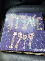 Front cover of the Prince 1999 album showing the colorful stylized text and starry purple background.