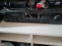 Front view photograph of the Sony audio video control center showing the control knobs, buttons, digital display, and brand logo.