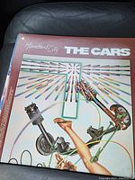 Photo of the album cover showing the title "Heartbeat City" and the band "The Cars" with colorful graphic design.