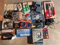 Overview of electrical supplies including outlets, switches, connectors, boxes, tools, and a multimeter.