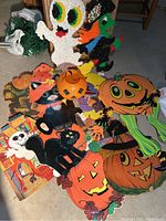 Full view of Halloween decorations including plastic popcorn ghost and witch and various cardboard cutouts with pumpkins and cats
