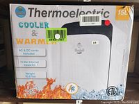 Front box image of Cooluli Thermoelectric Cooler & Warmer showing model details, capacity (15 liters), and features including AC & DC cords.