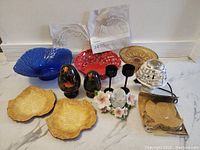 Full view of all 14 assorted home decor items displaying variety of bowls, decorative containers, candle holders, coasters, and doilies