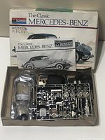 Box and instruction manuals for the Monogram Classic Mercedes-Benz model kit with artwork of the assembled car.