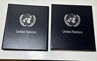 Front covers of two black Davo leather-bound binders with United Nations logo