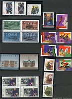 Photo of a collection of 22 Canadian mint postage stamps arranged on a black background showing various commemorative and thematic designs from historical to sports subjects.