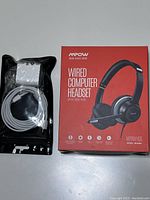 MPOW wired computer headset in original red box with a separate image of back with specifications.